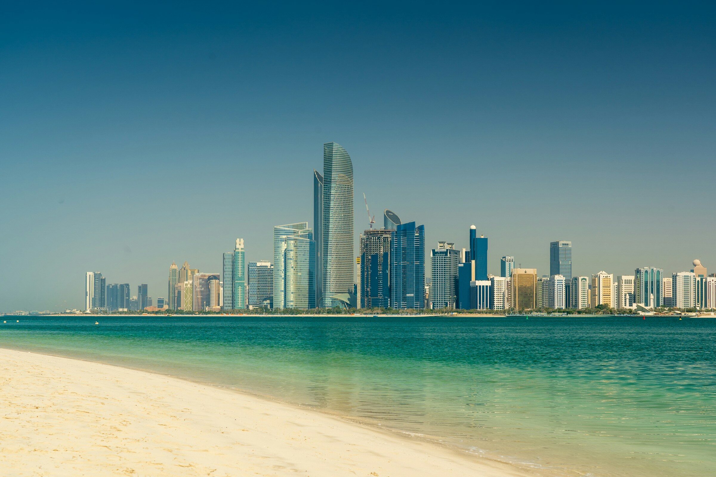 The Abu Dhabi skyline across the sea by day
