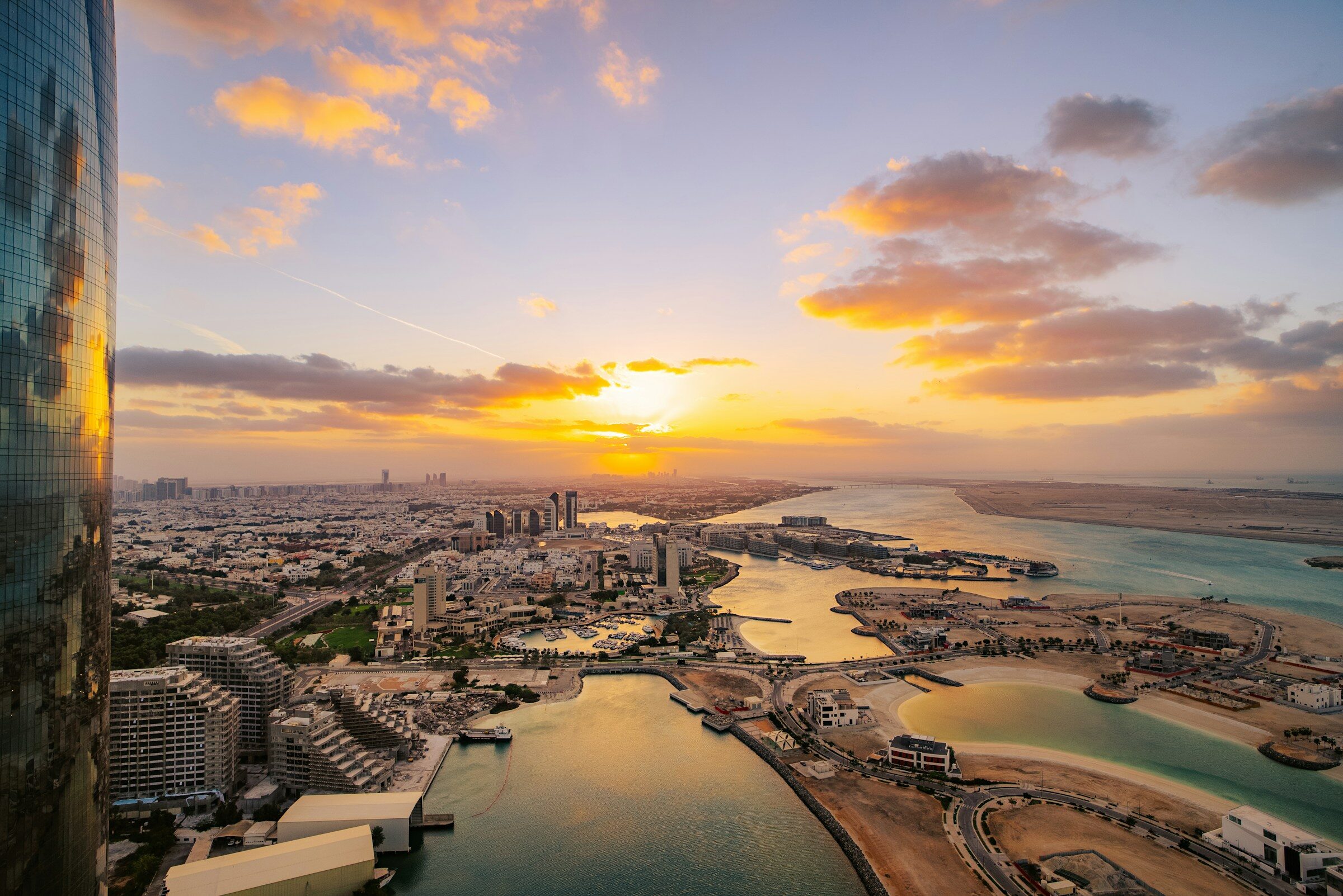 The sun setting over Abu Dhabi and the water