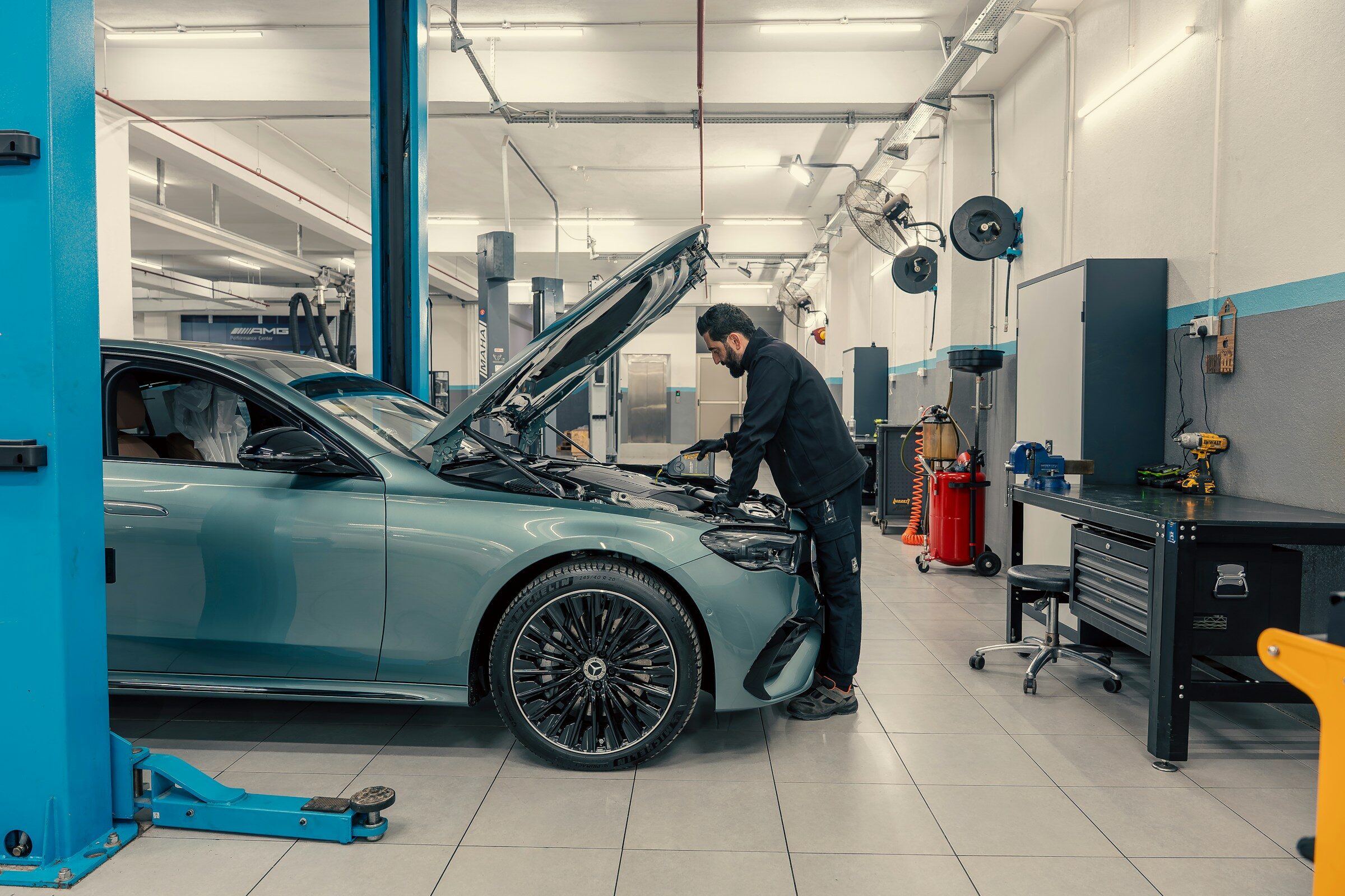 A mechanic working on a car engine in a workshop