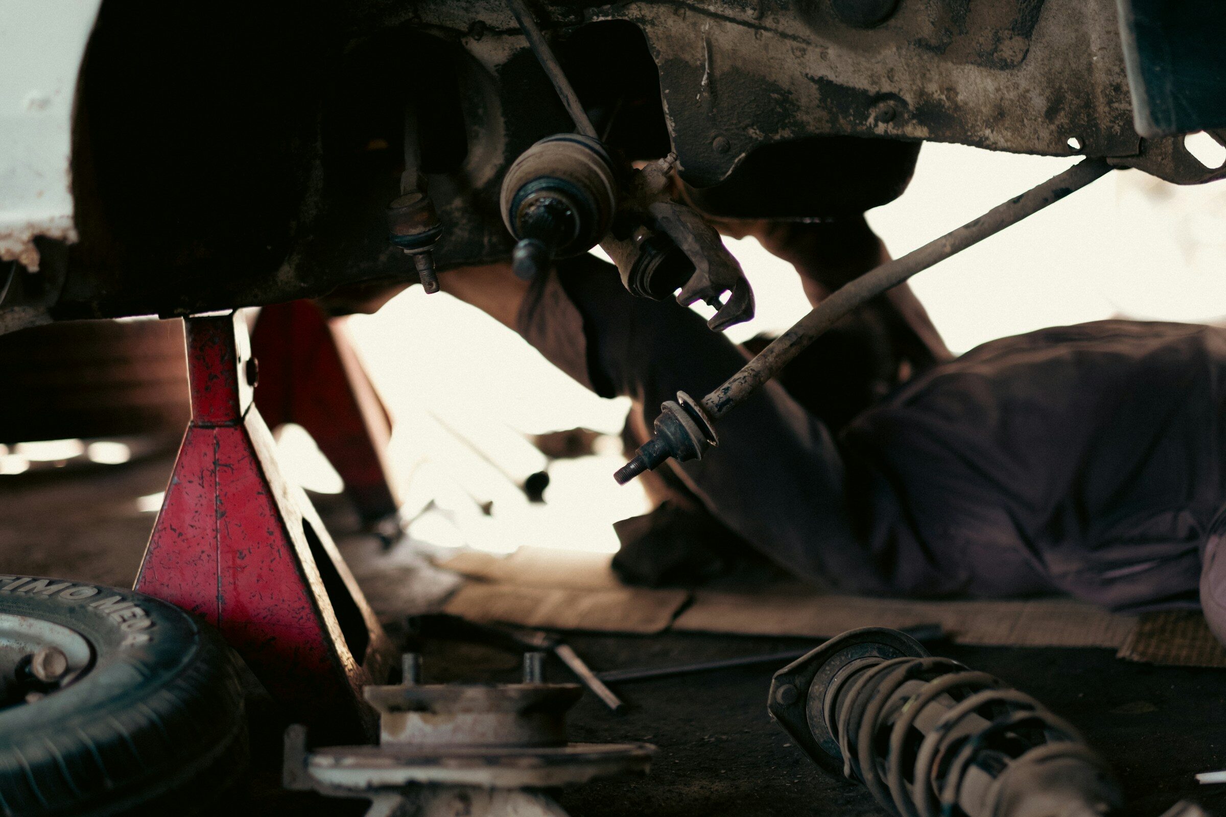 A mechanic working under a vehicle