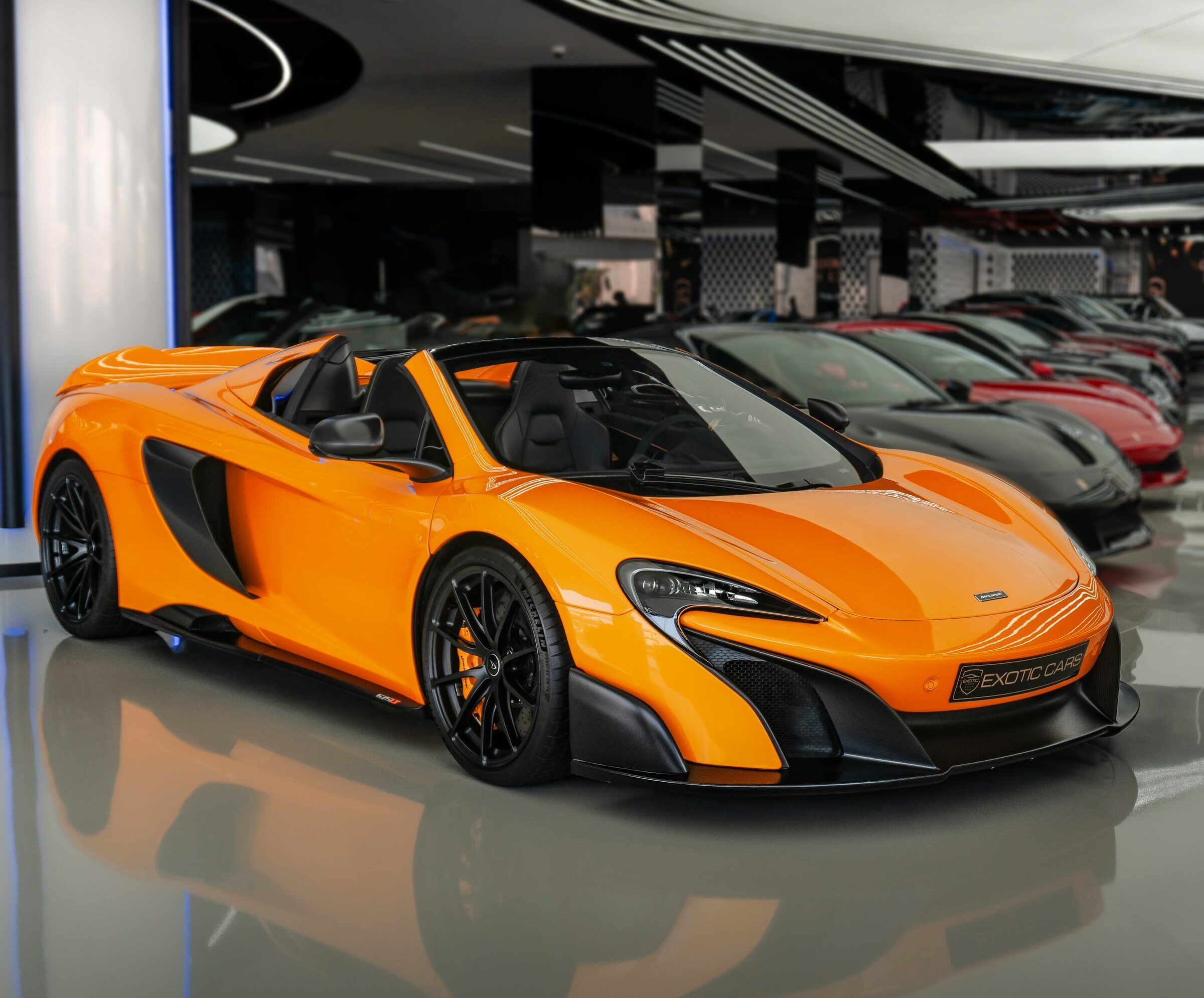An orange sports car in a showroom
