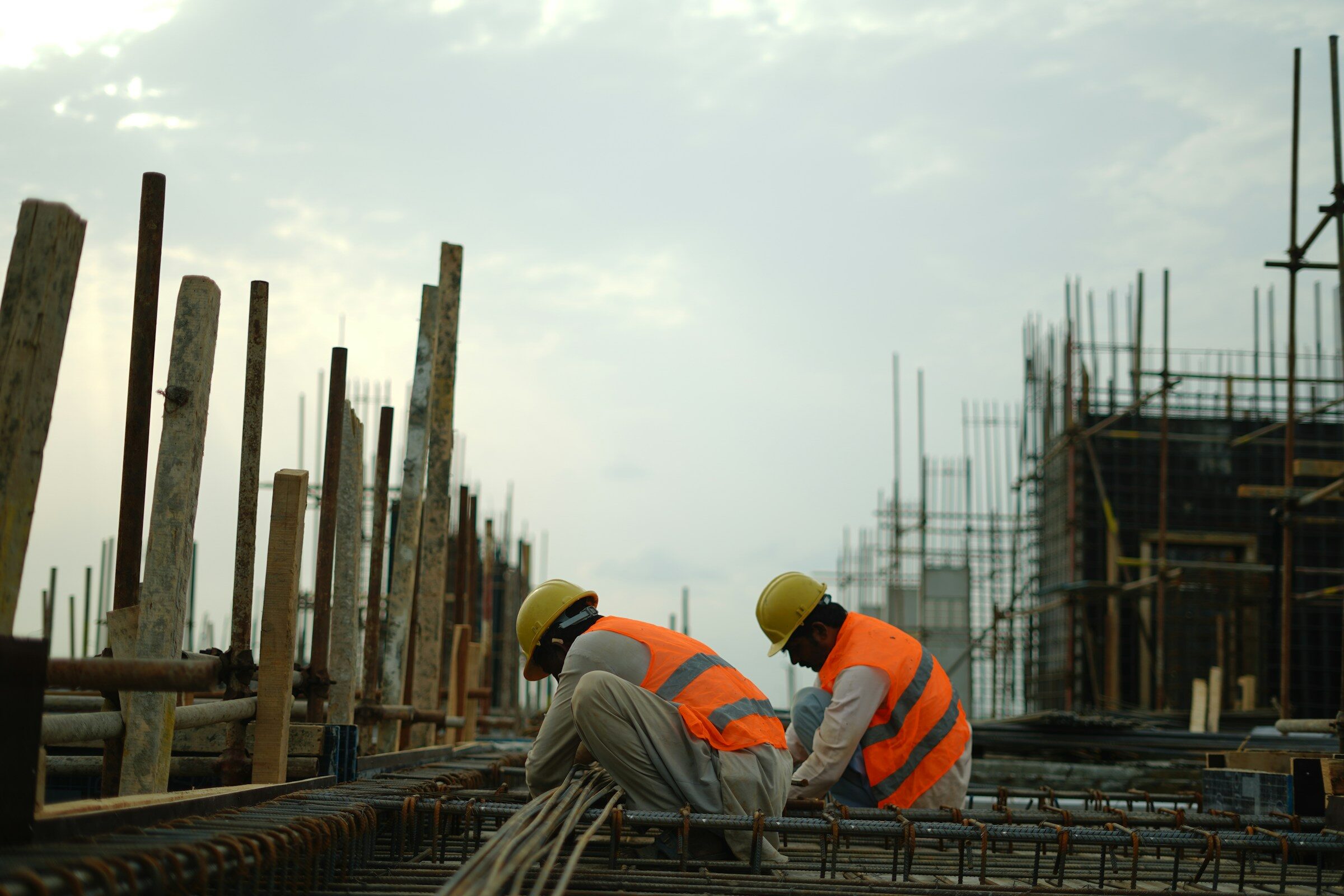 Construction workers in hard hats and safety vests on site
