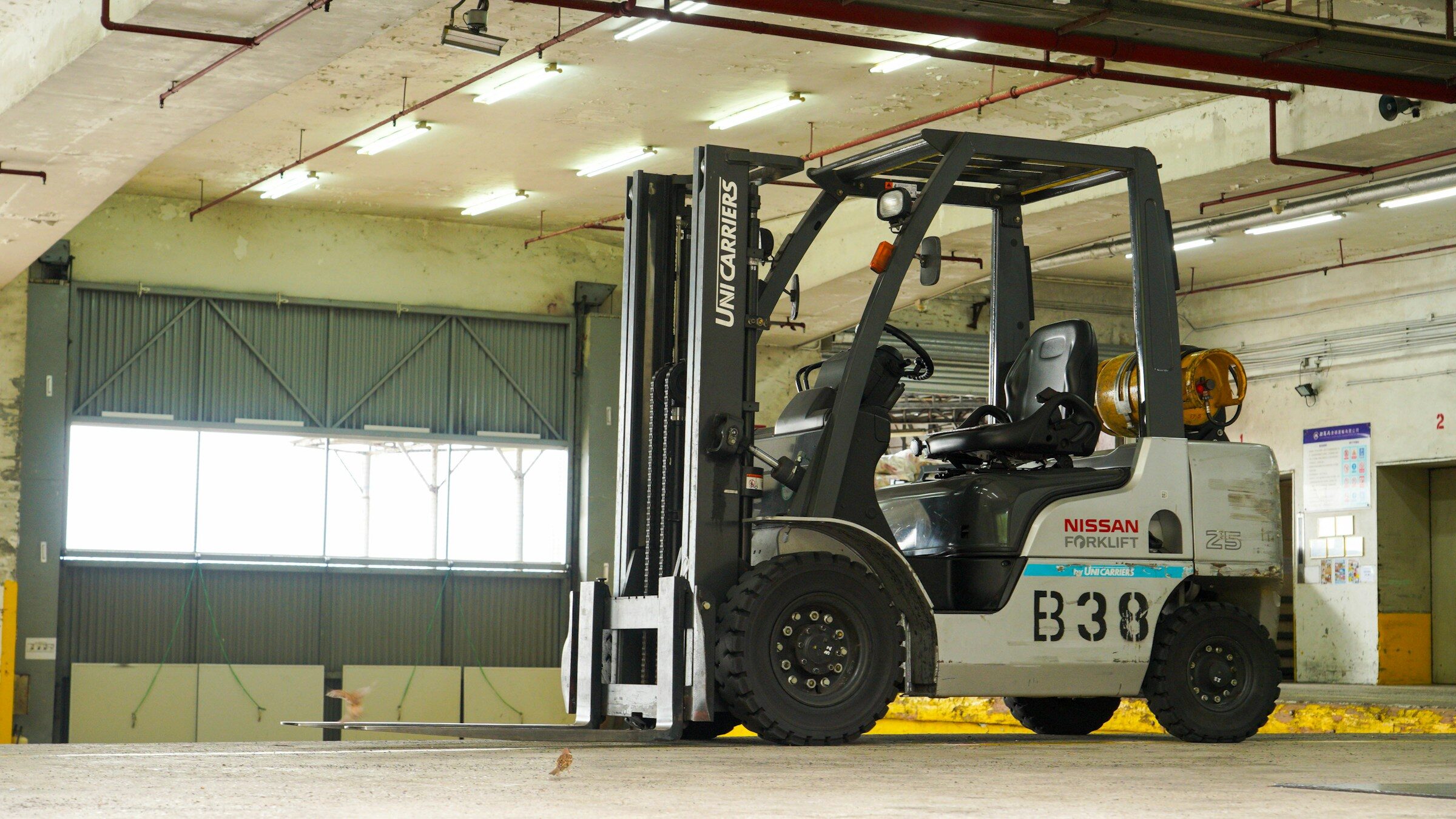 A forklift parked inside a parts warehouse