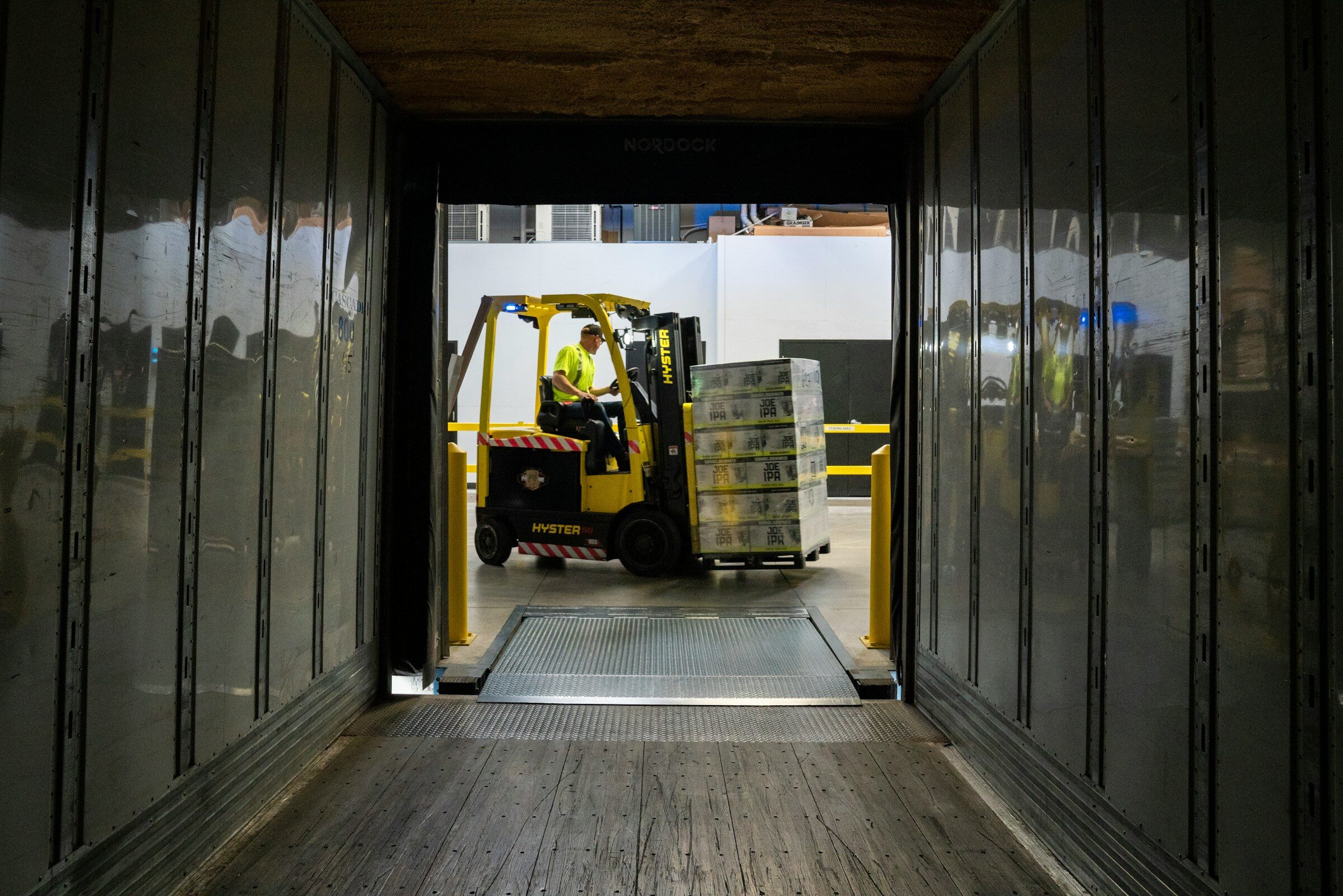 A forklift loading a truck from the loading bay