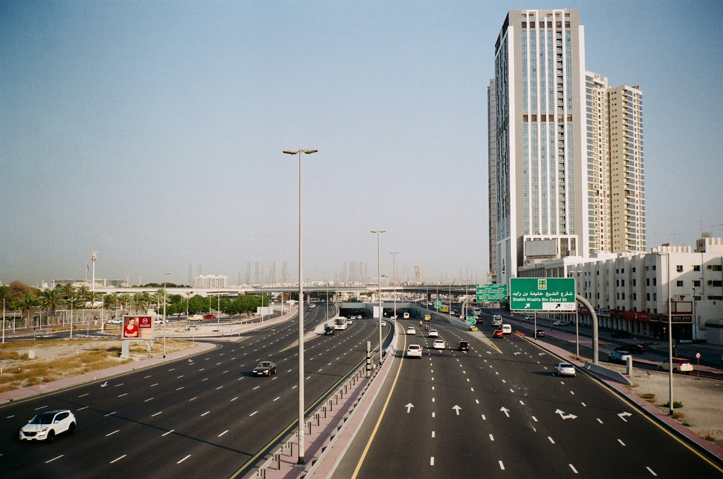 A Dubai highway with vehicles and towers