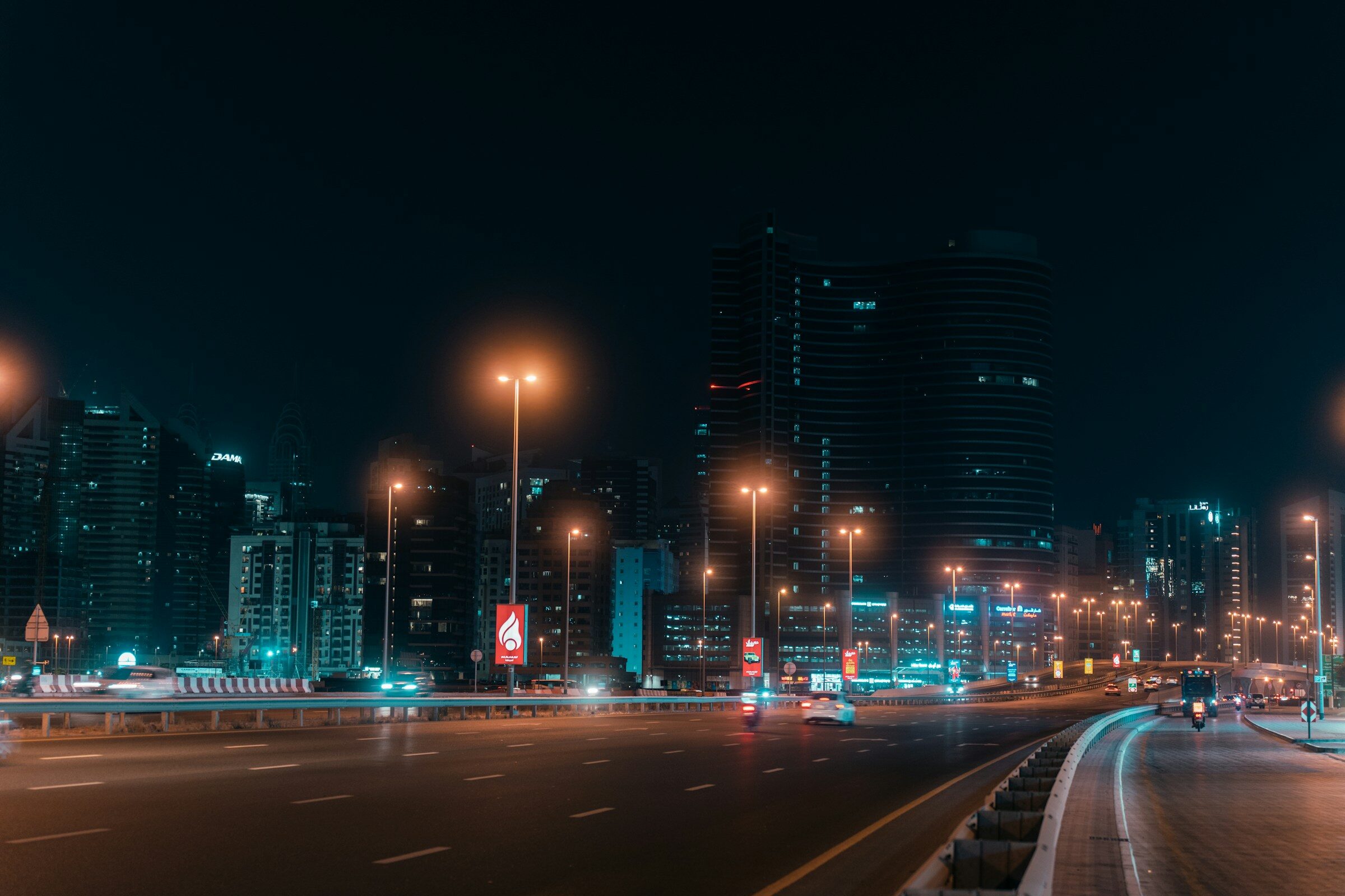 A Dubai street at night, full of light