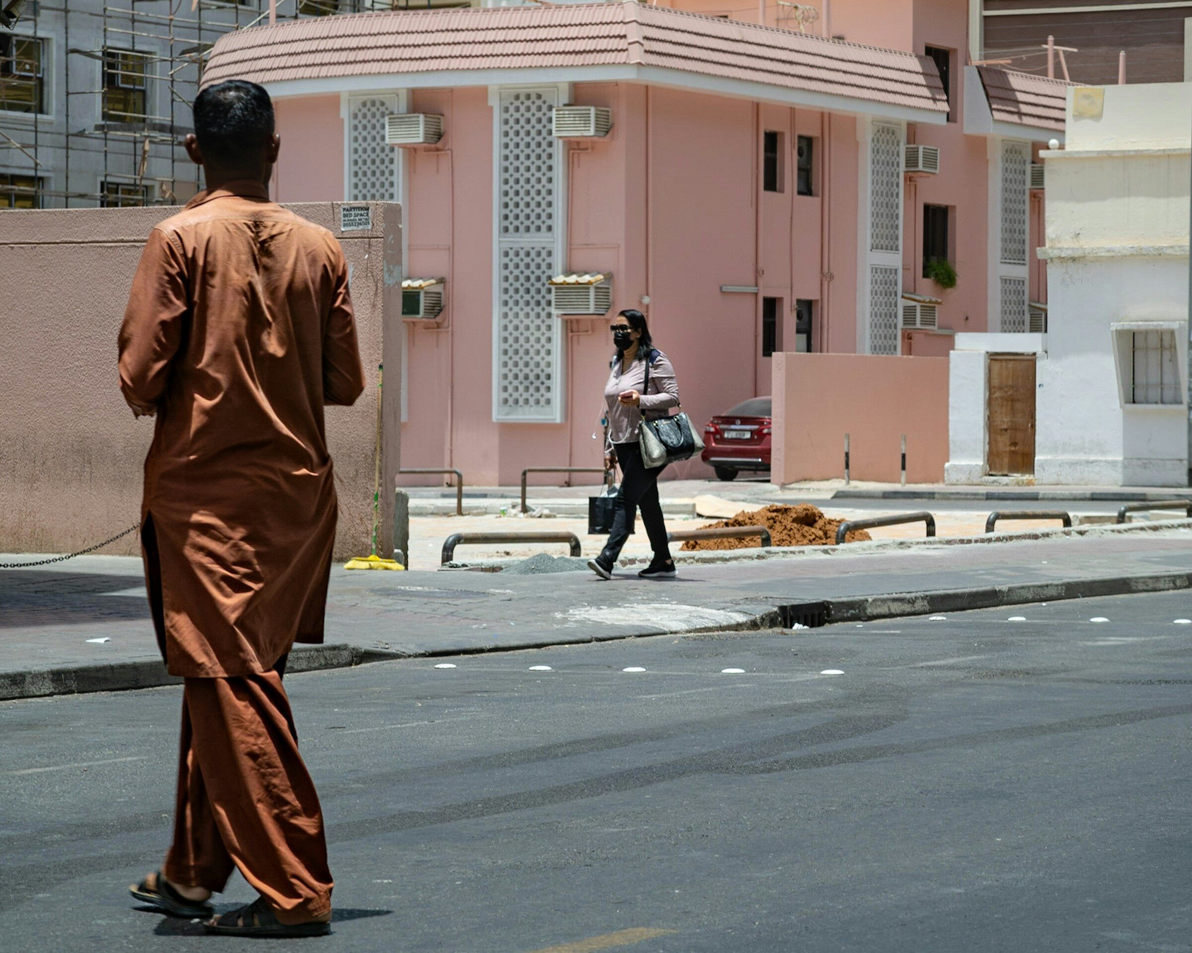 Two people walking down a Dubai street