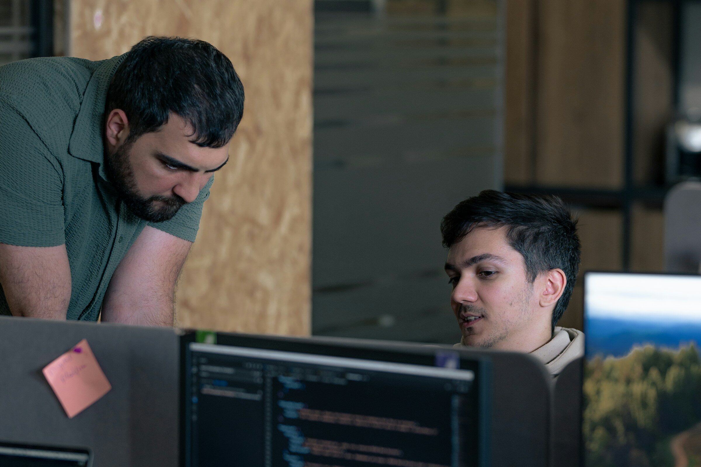 A pair building a module at office computers