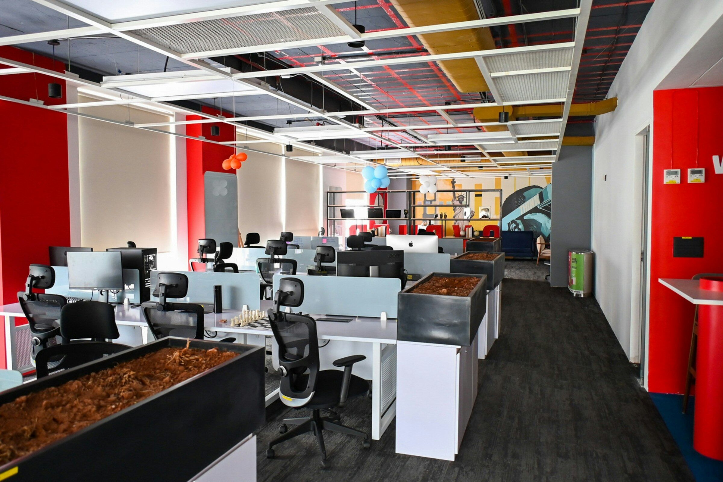 Workstations across an open-plan delivery floor