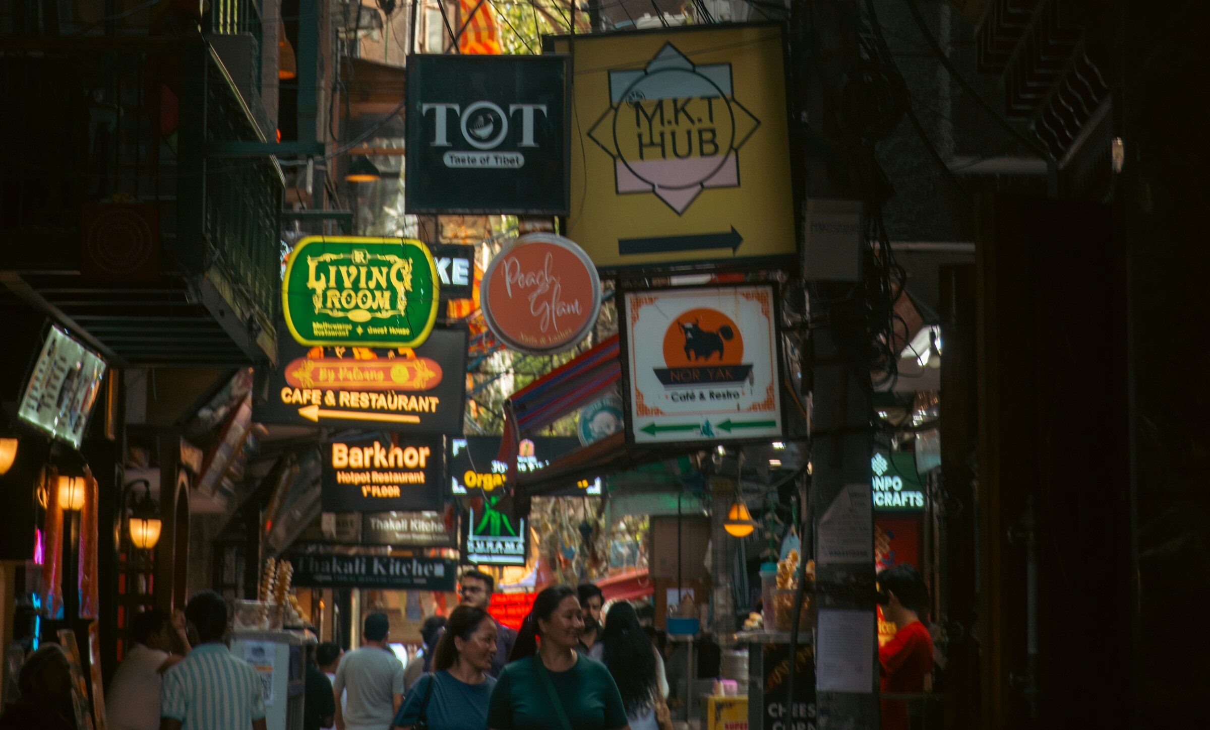 A busy street with many signs in several scripts