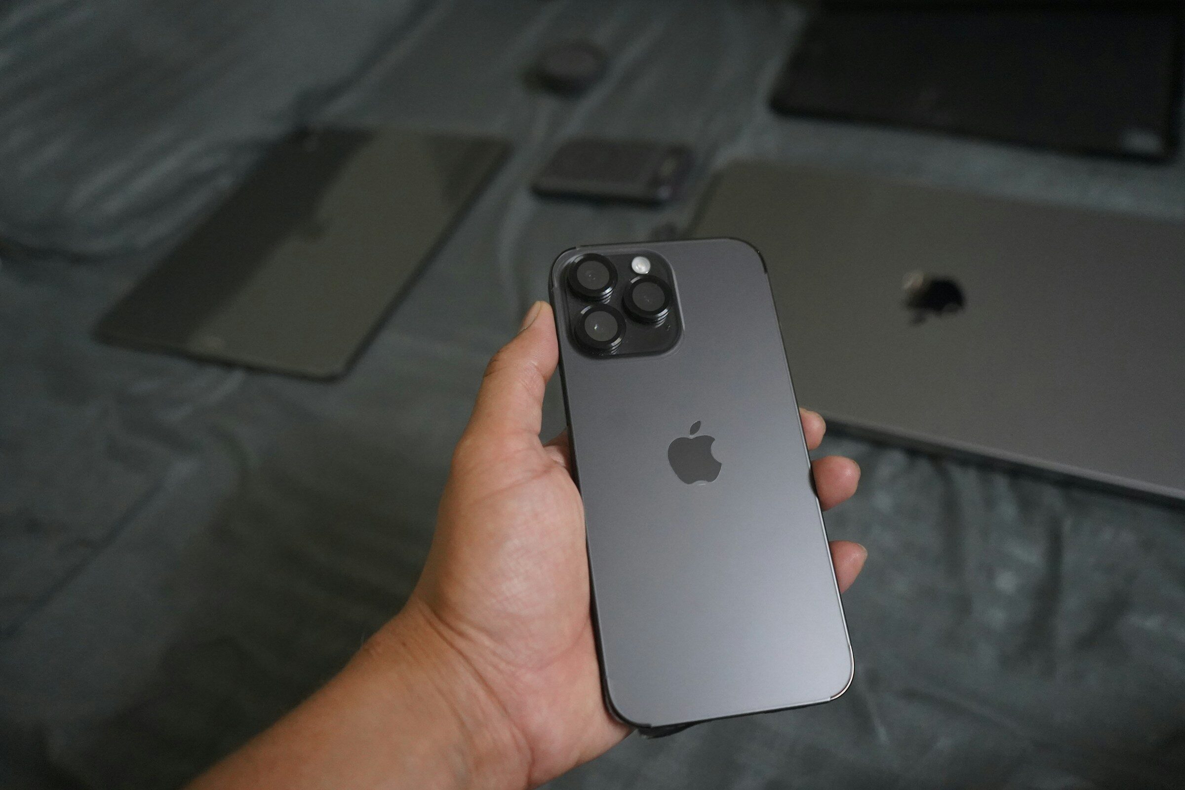 A hand holding a grey smartphone