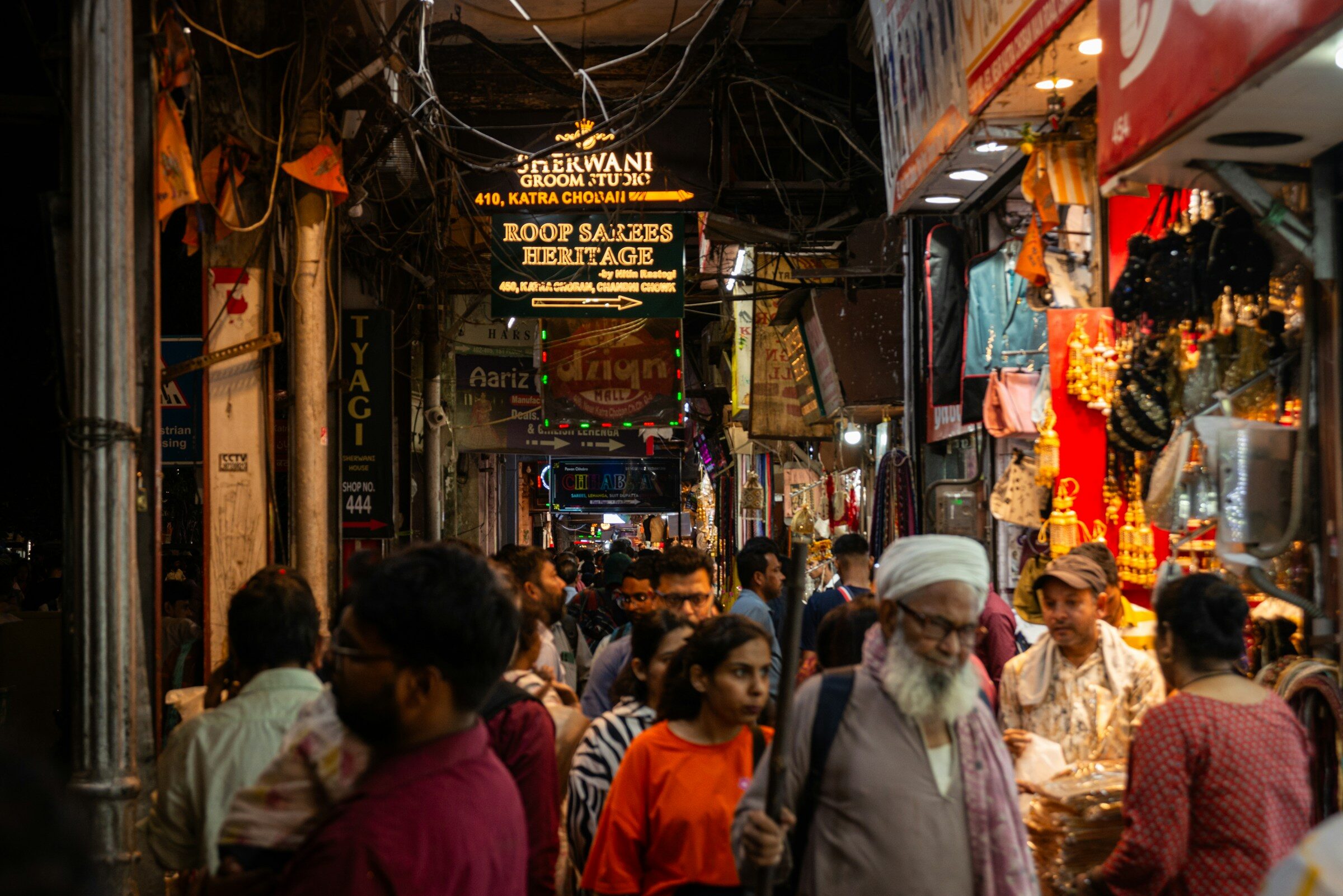 A crowded street market with shops and people