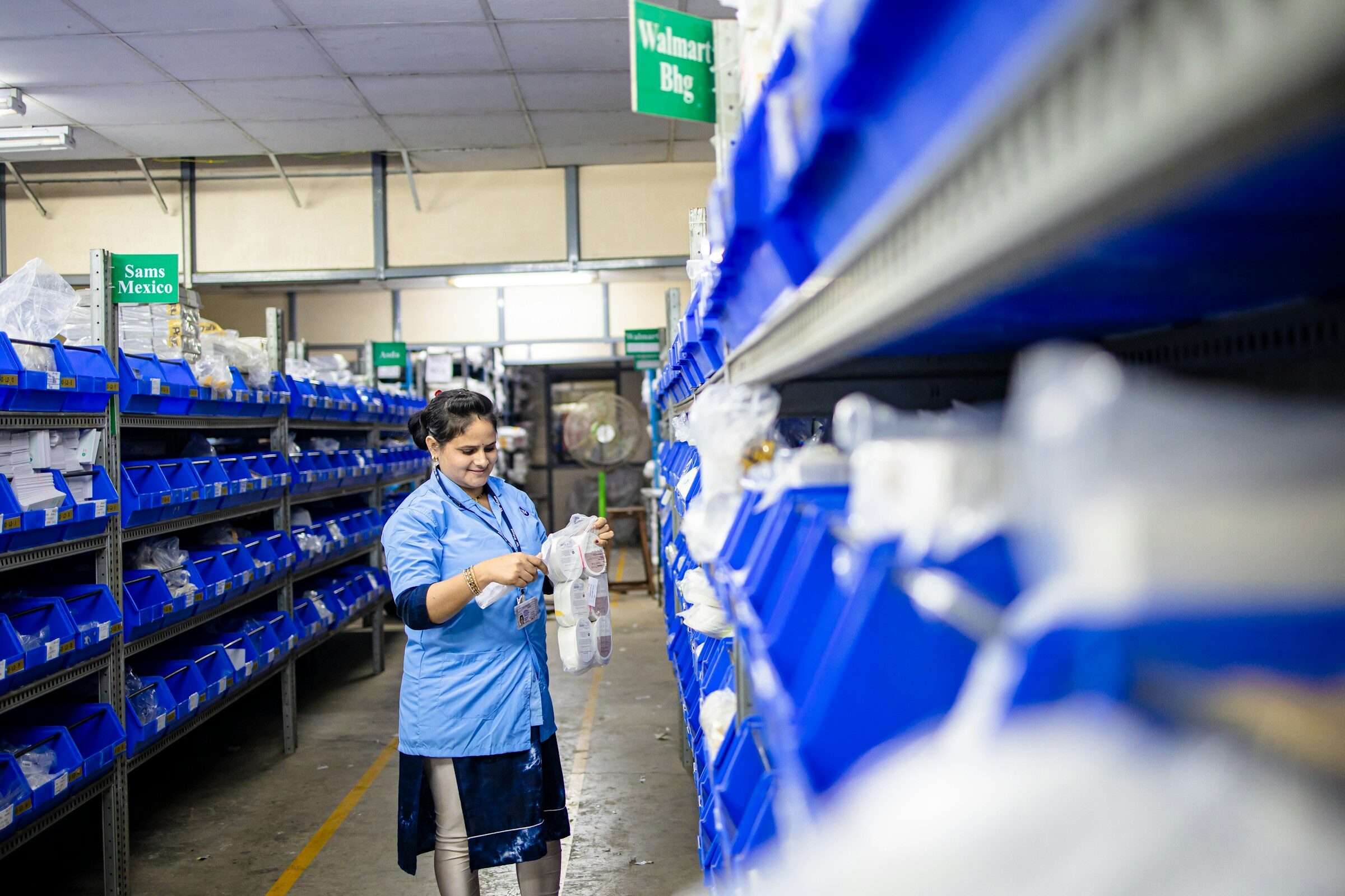 Logistics manager in an organised warehouse scanning inventory