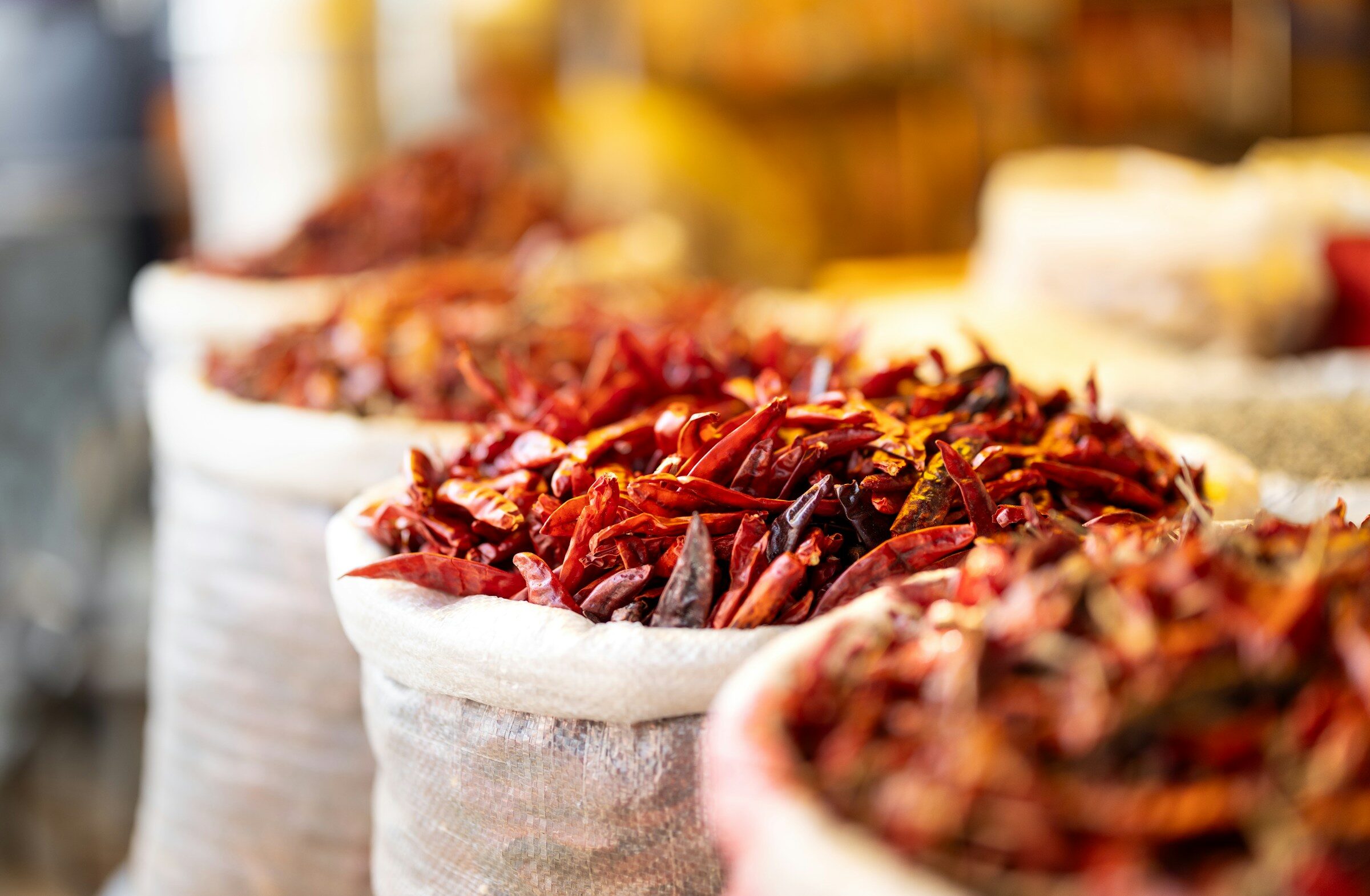 Dried red chillies in bags at a market