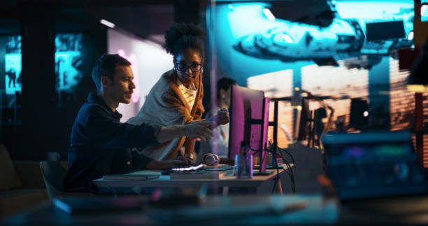 Designers reviewing website layouts together in a studio