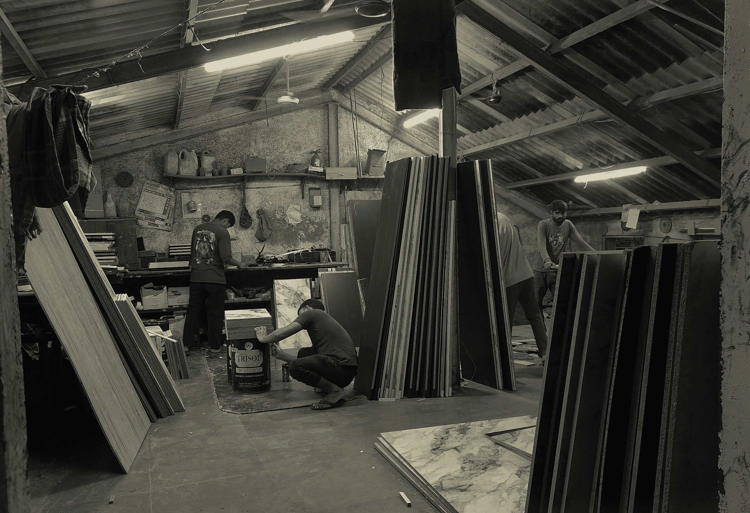 A small manufacturing shop with stock stacked along the wall