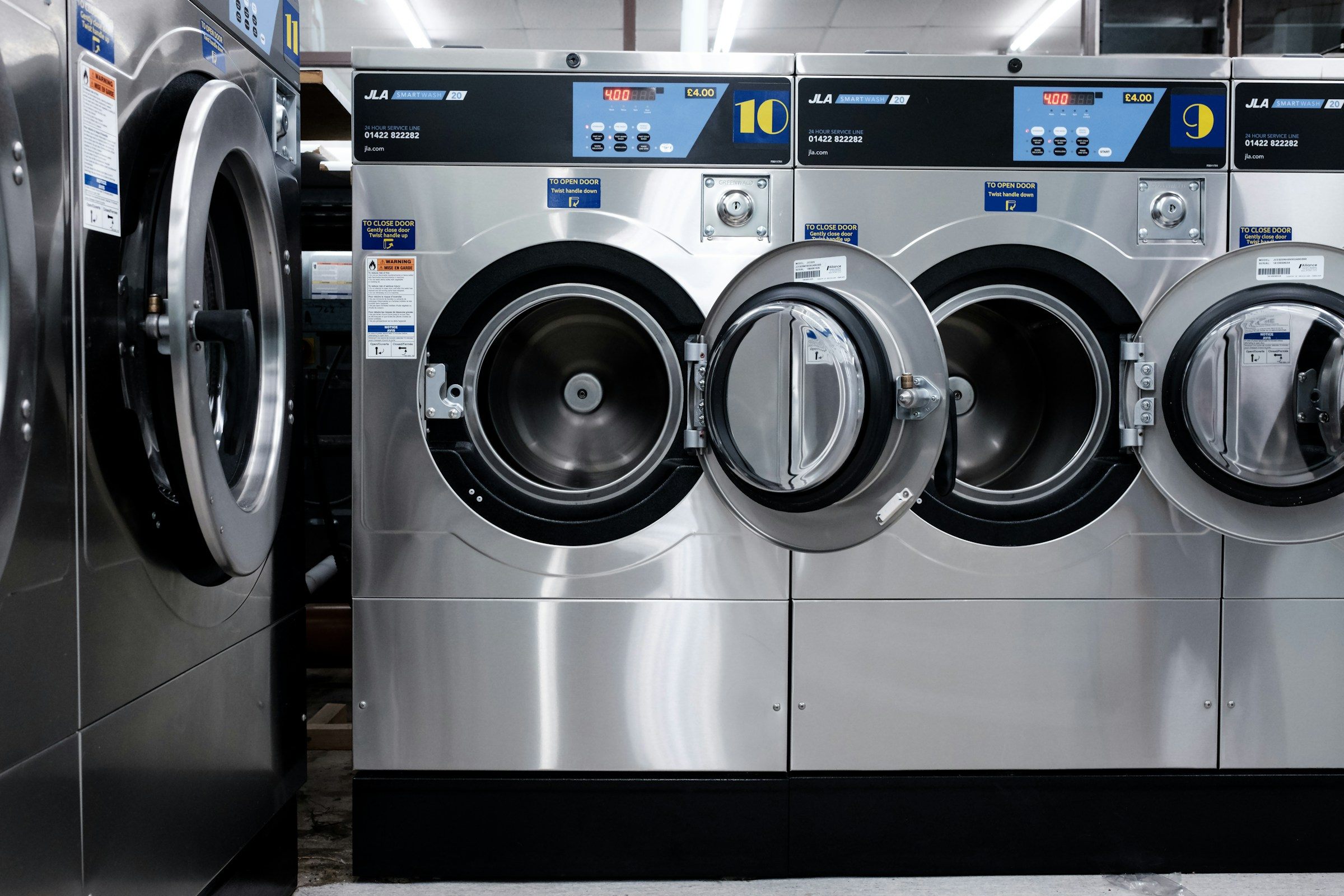 A row of front-loading washing machines
