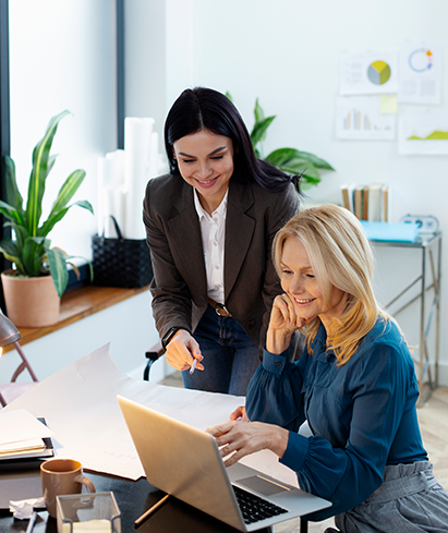 Two colleagues reviewing a content plan document