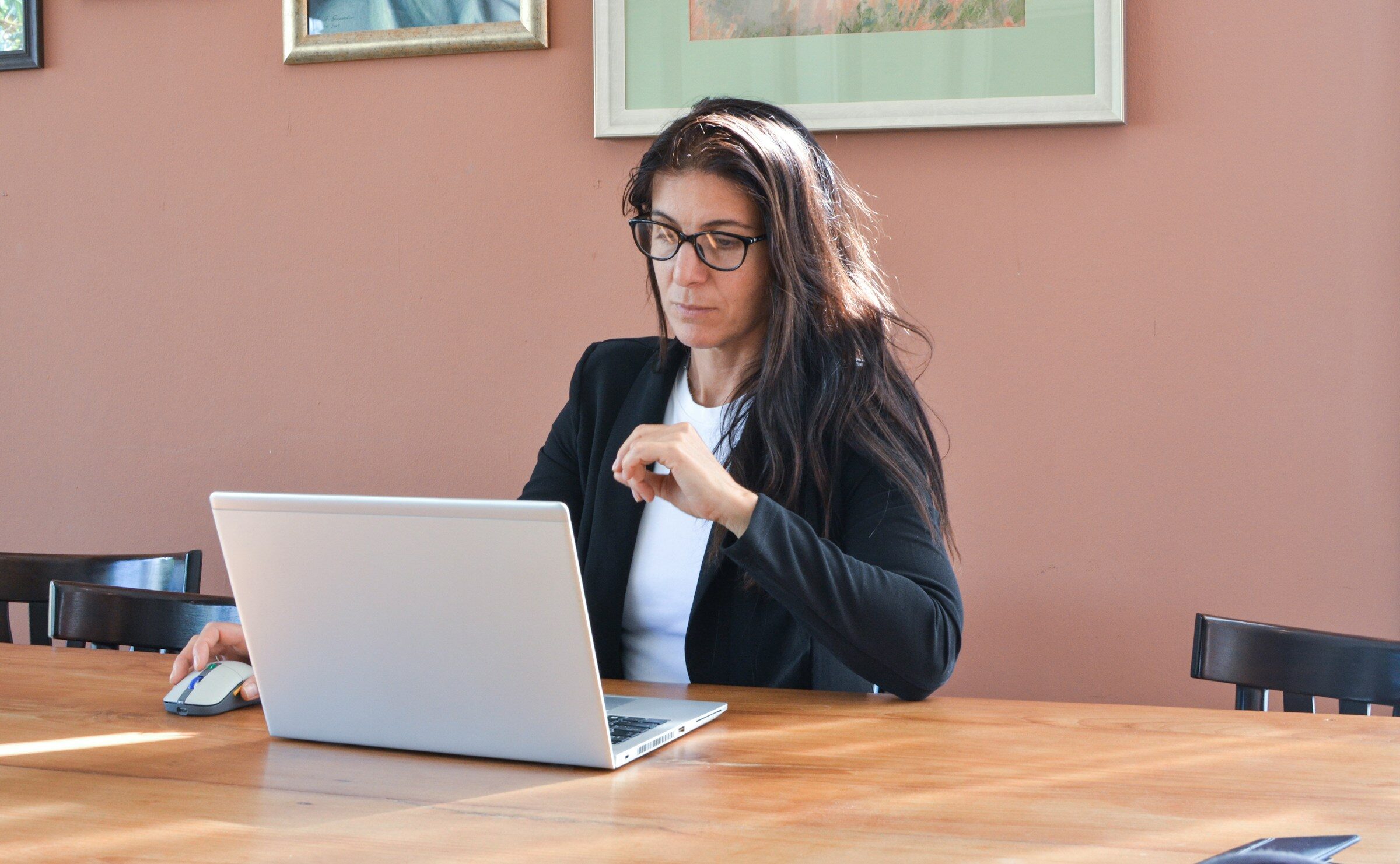 An analyst working through a technical report on a laptop