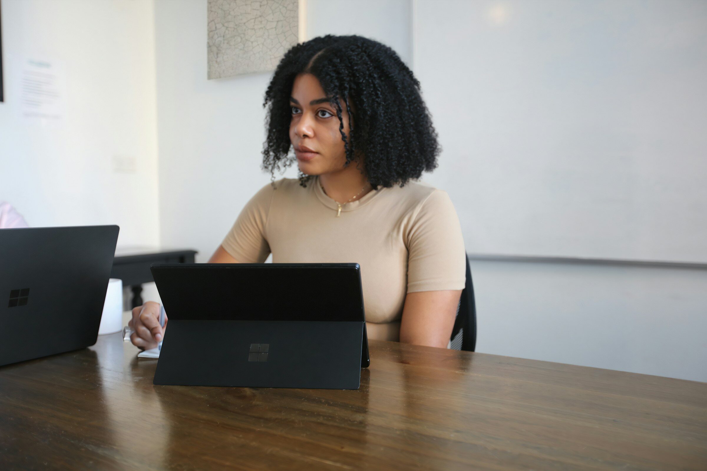 A board room review with a laptop open on the table