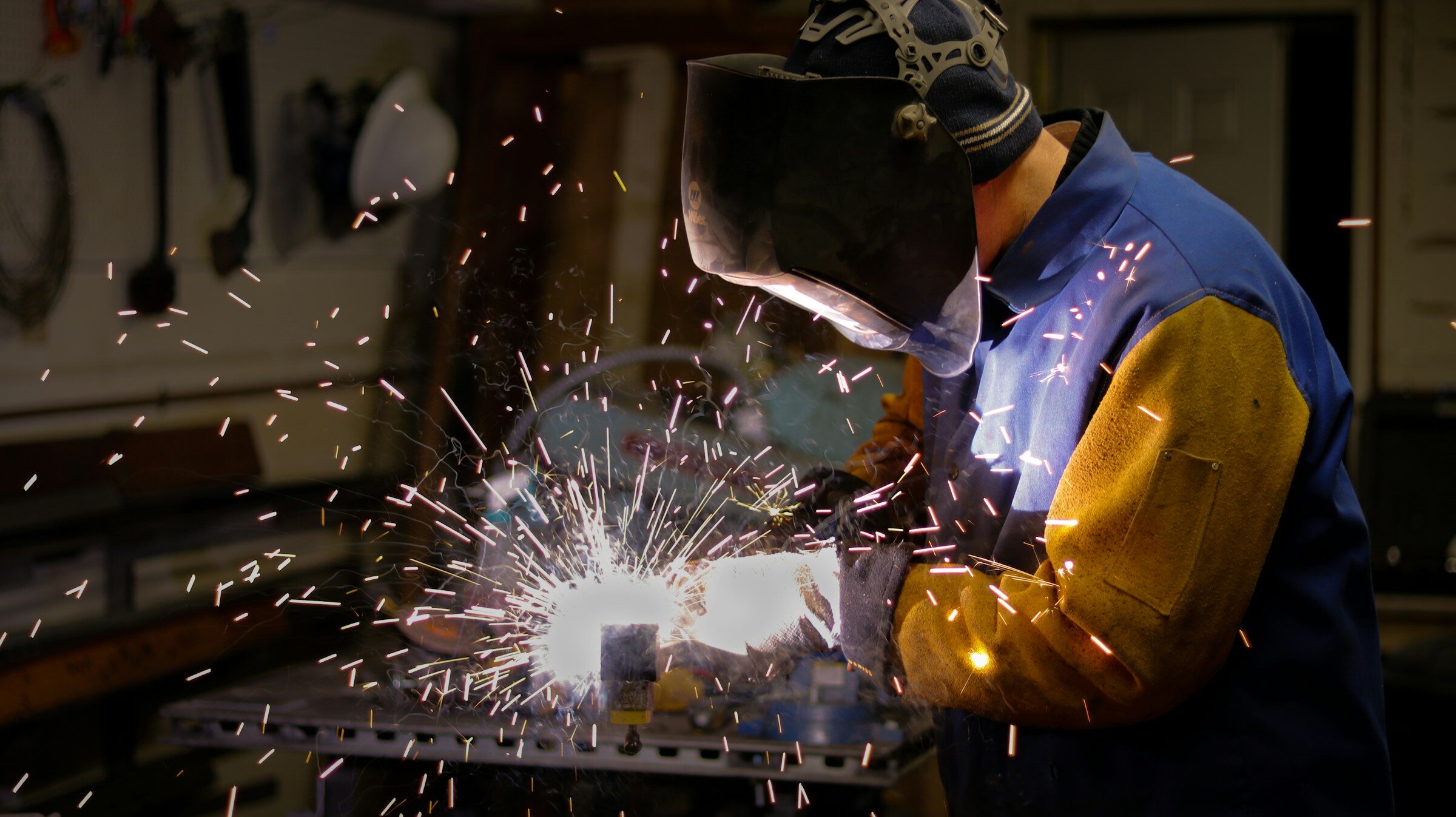 Operator in protective gear working a fabrication machine