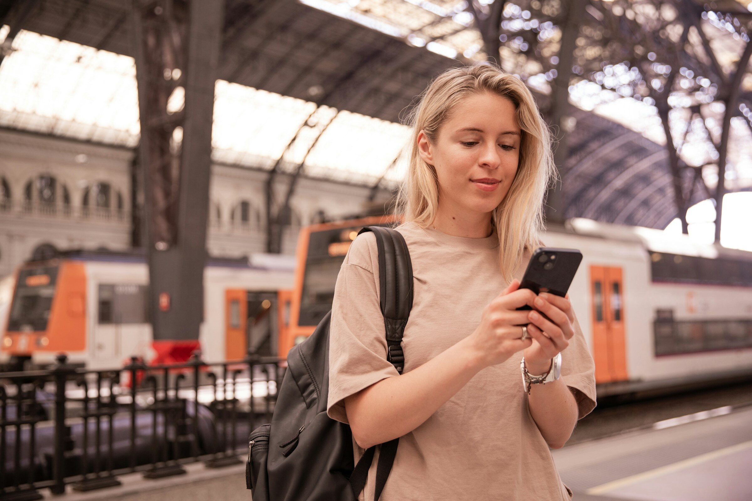 Commuter checking a phone on a station platform
