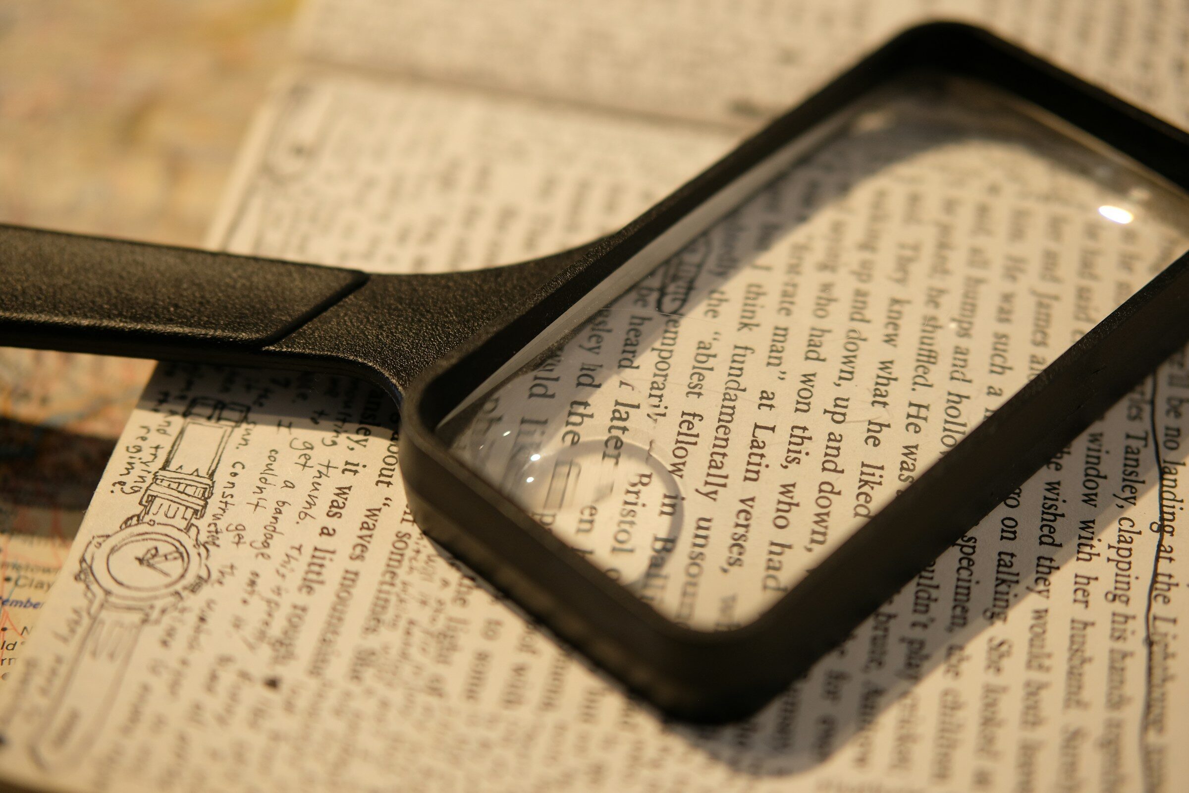 A magnifying glass over printed text, which is roughly what viewing source is