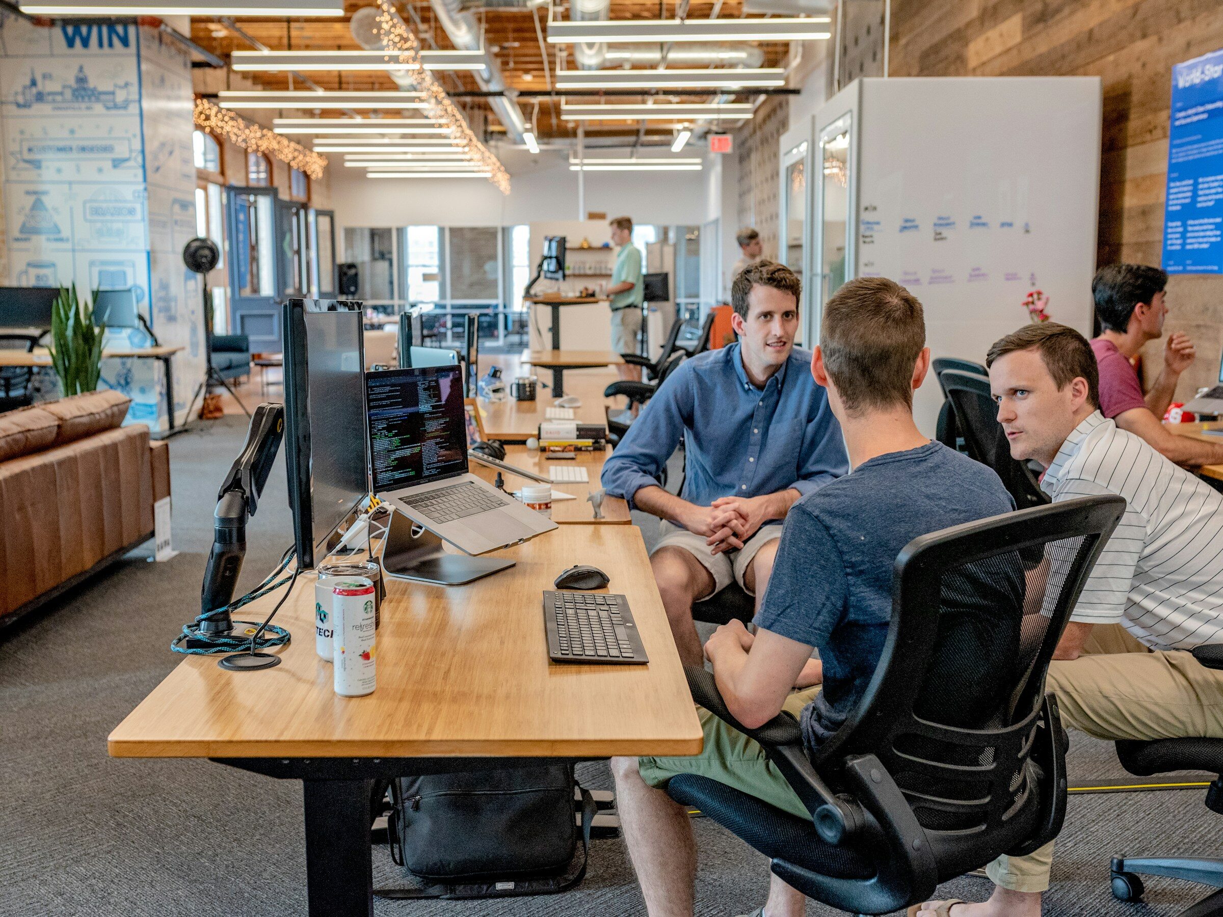 Three colleagues working at adjoining desks